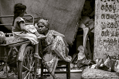 image of woman and girl sitting on a cart